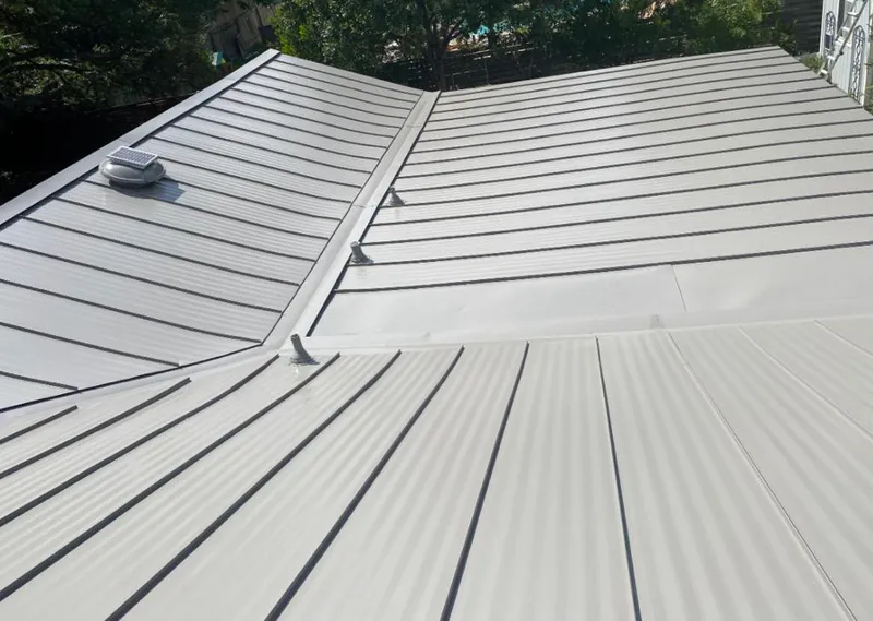 Solar attic fan installed on a metal roof for Roof Ventilation in Kewanee
